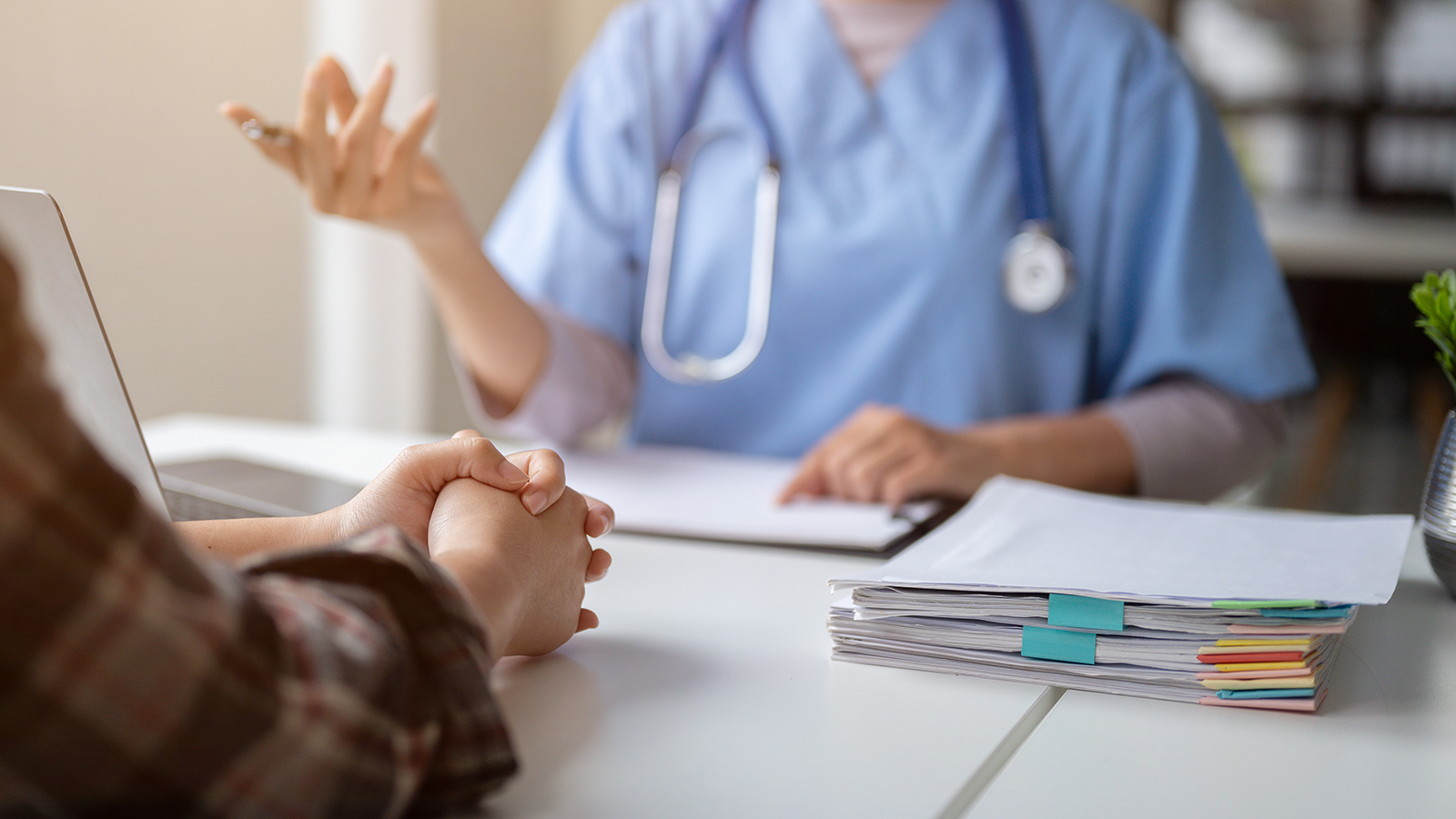 woman having a consultation with a doctor wearing scrubs