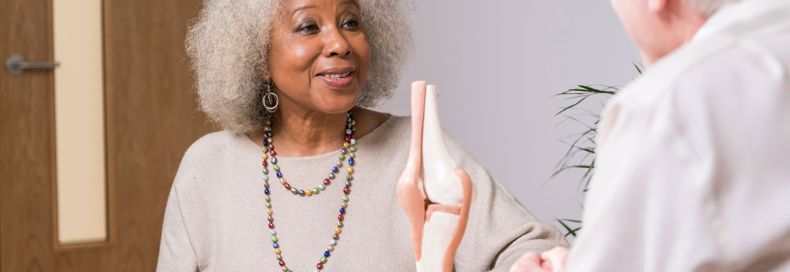 Attractive older woman having a consultation about joint problems