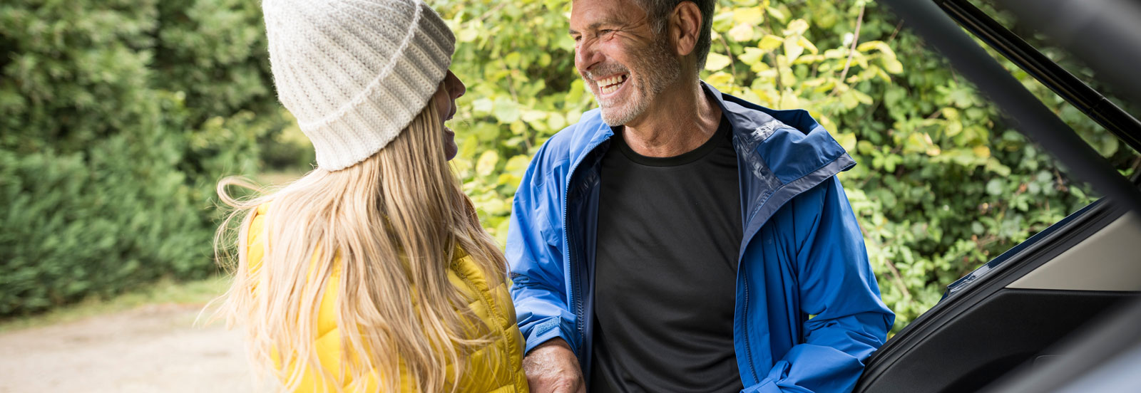 Man and his grown up daughter getting ready for a walk in the woods
