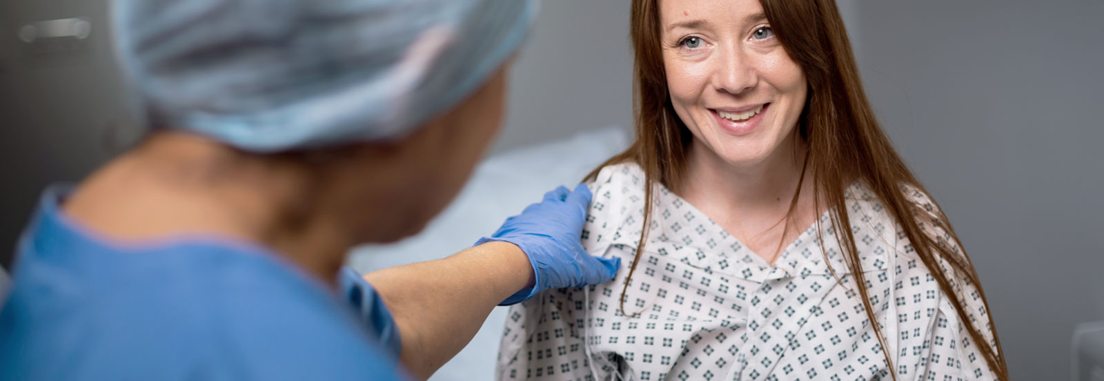 woman in her 30s receiving positive news from a consultant after surgery