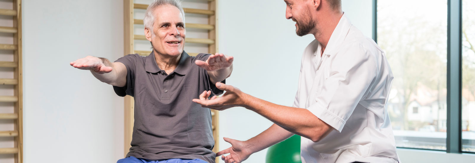 Man in his 60s on pilates ball during physiotherpay session