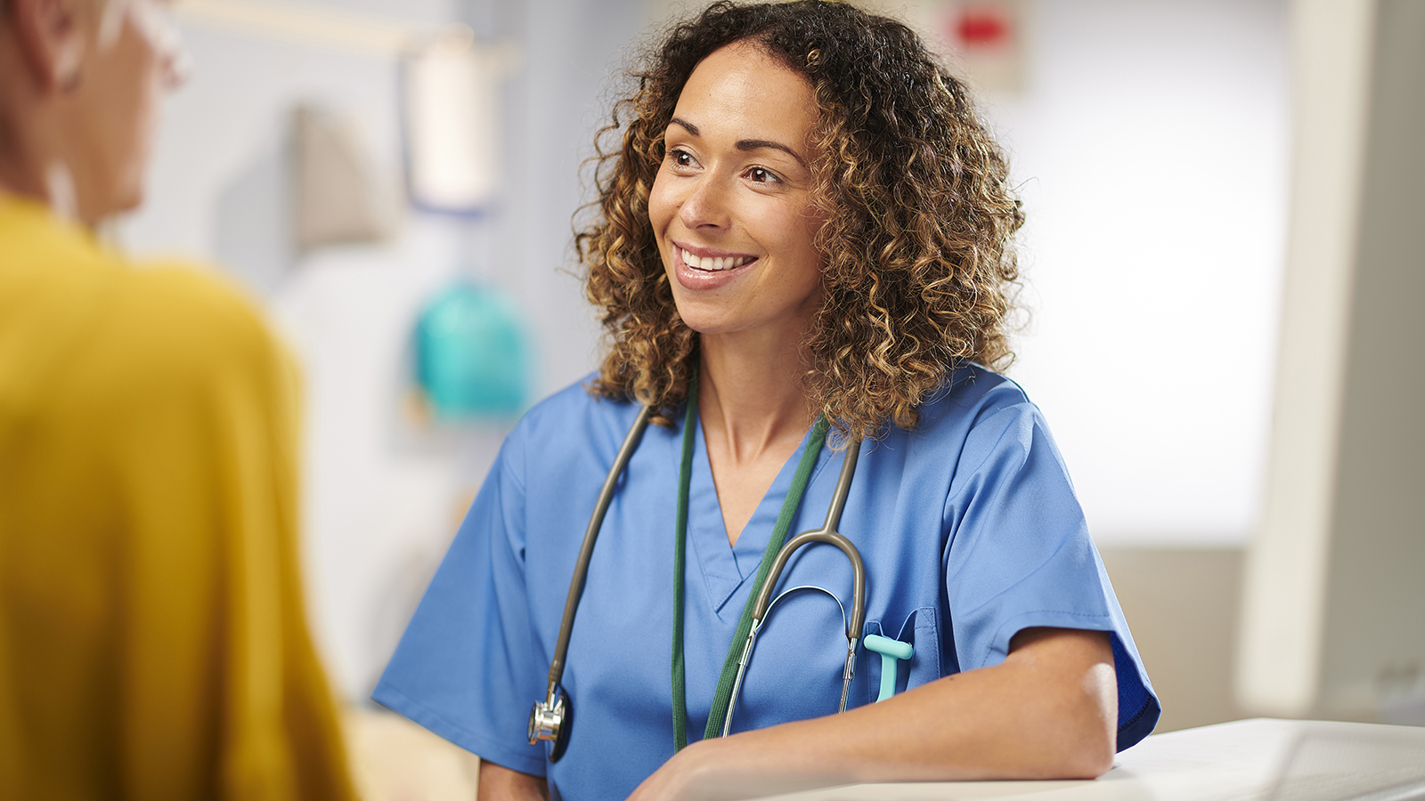 young female doctor sharing positive news with a patient