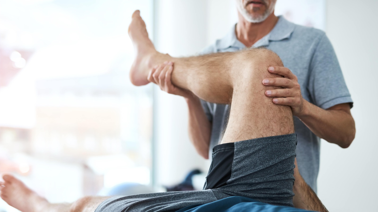 man having physiotherapy after knee replacement surgery