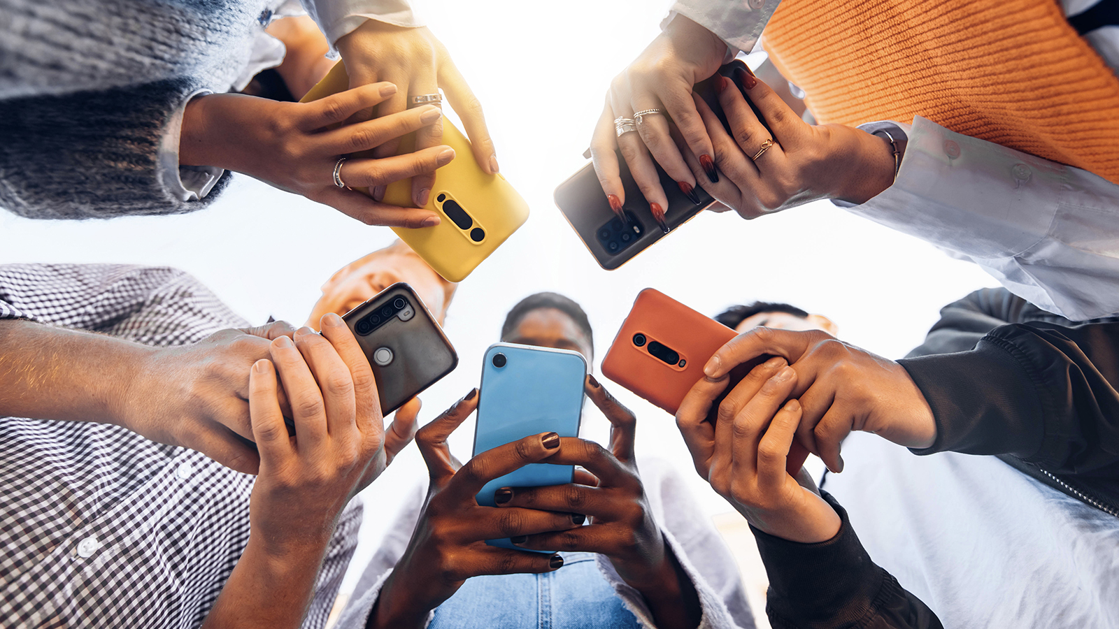 group of people all ignoring each other to use their phones