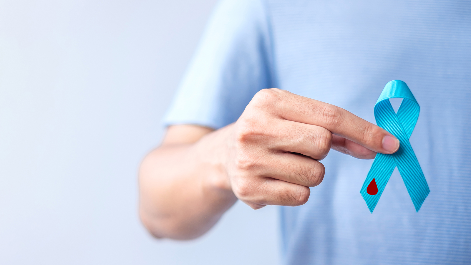 person holding a blue ribbon representing diabetes awareness