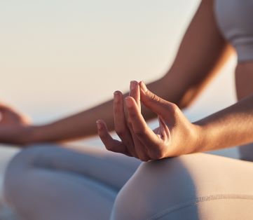 woman meditating outside showing self care