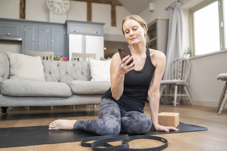 woman looking at phone after excercising
