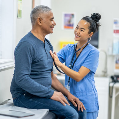 Healthcare professional listening to a patient’s chest using a stethoscope