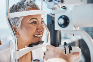 Lady getting an eye check by a consultant