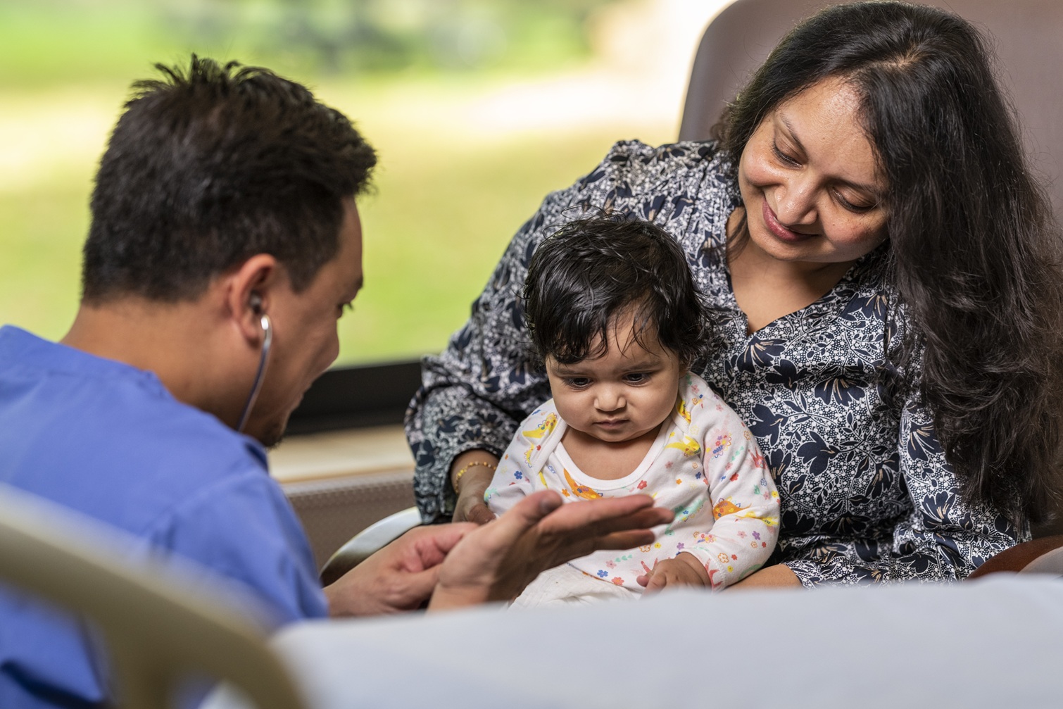Private hospital consultant with patient mother and child