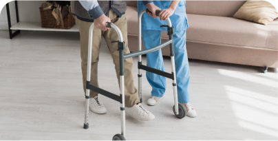 patient walking with a walker and a nurse supporting him