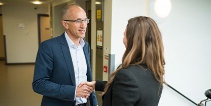 Two corporate staff hand shaking