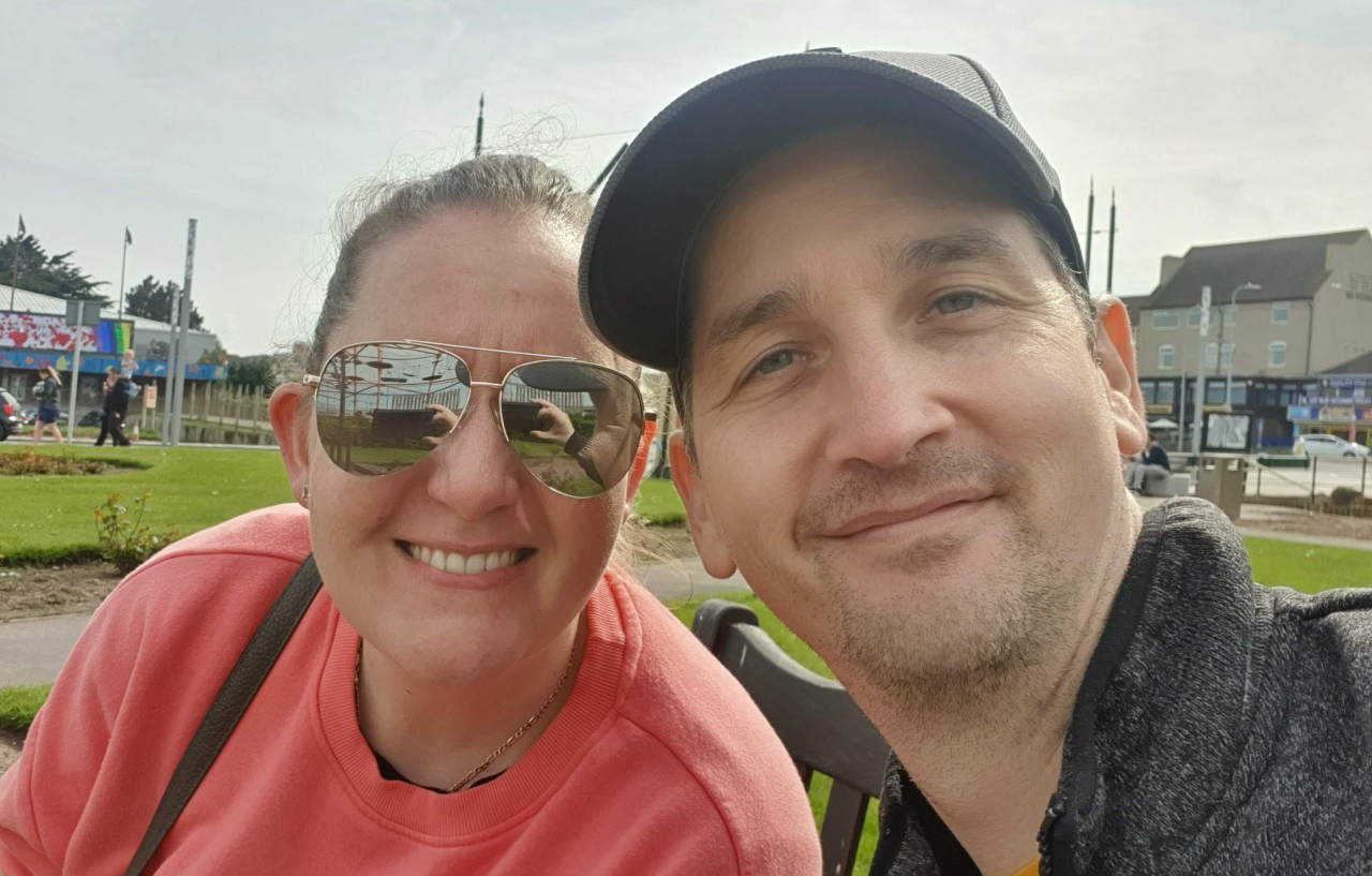 Paul Jenkins smiles at camera with wife