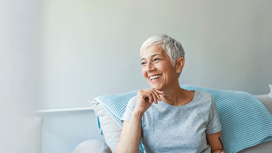 old lady smiling sitting in a couch
