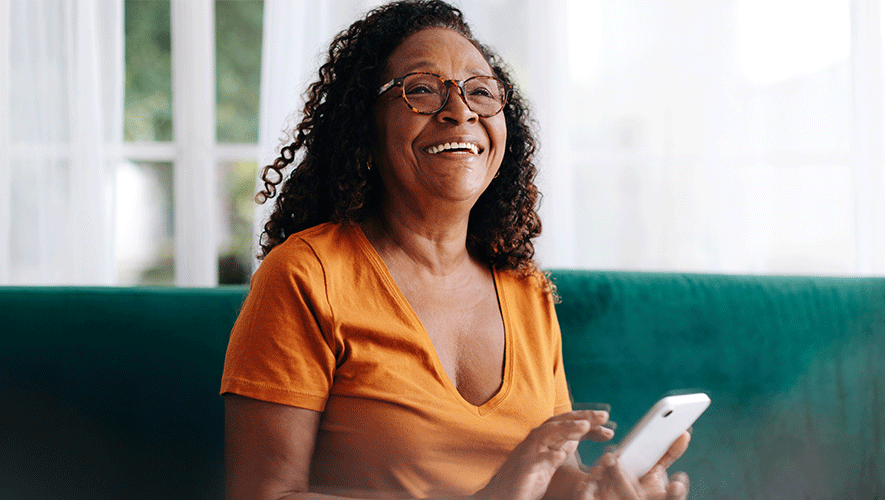 old lady smiling while using phone