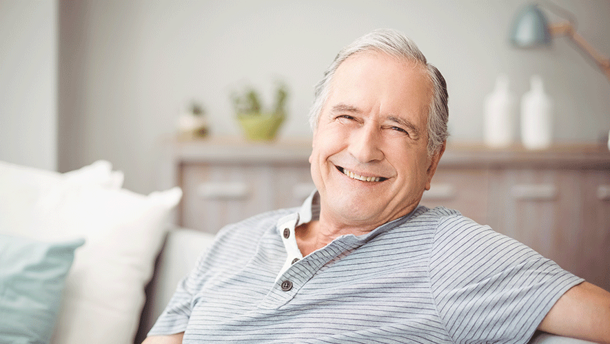 old man smiling in a couch