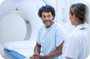 patient and private hospital staff member next to scanner