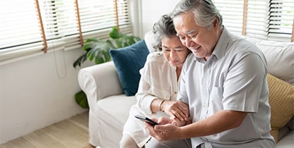 Man and woman looking at a mobile phone man is holding
