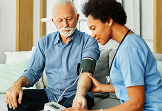 Senior male patient having their blood pressure taken