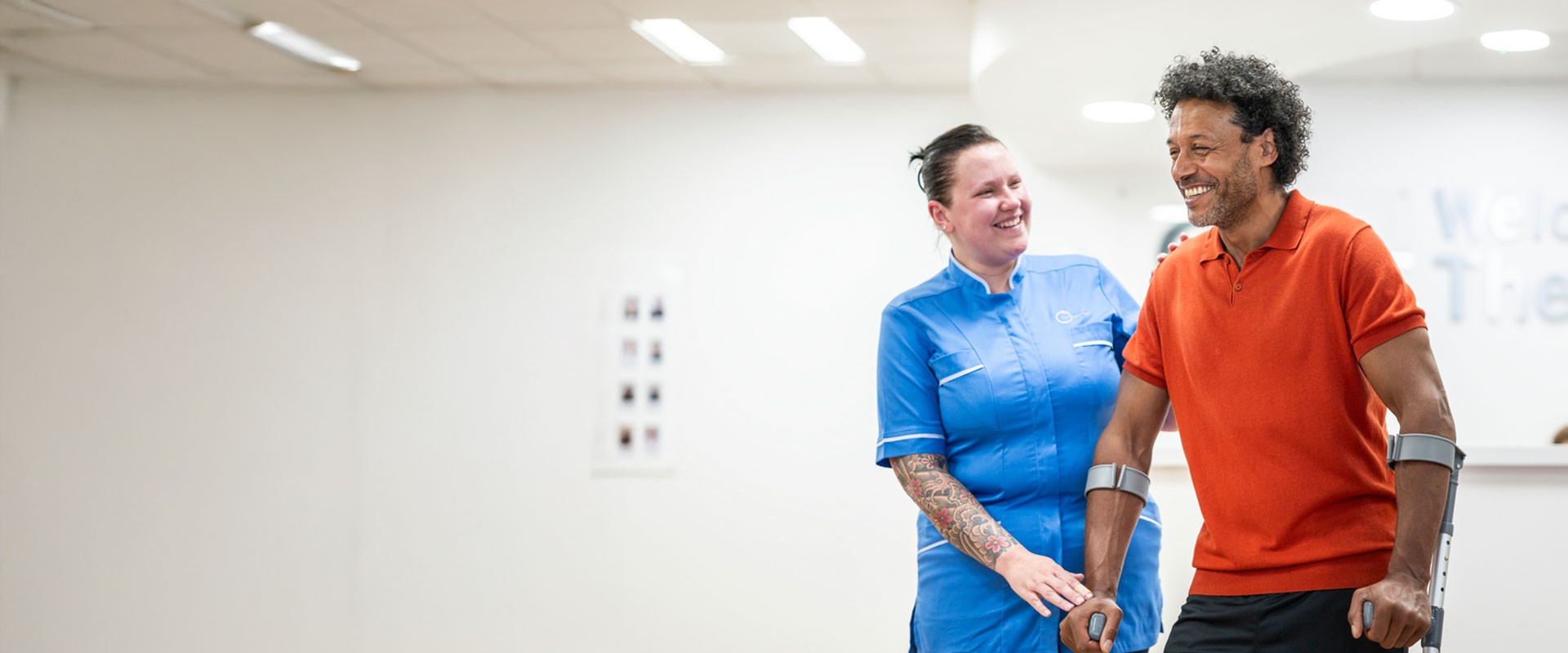 Private patient on crutches being supported by nurse