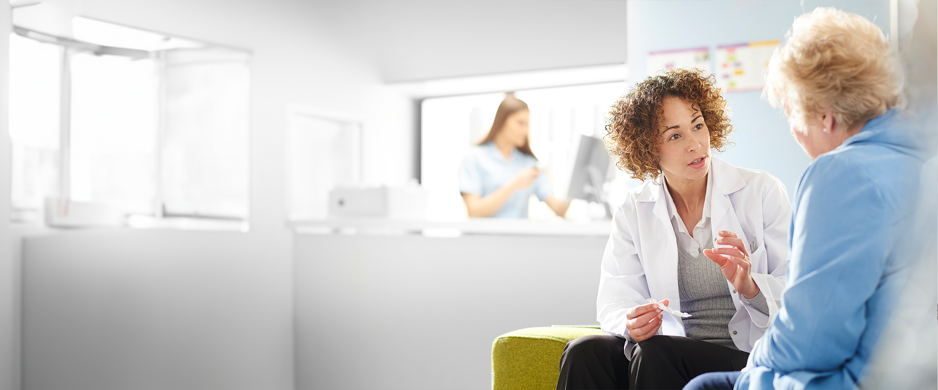 consultant talking to patient in consulting room