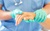 Close view of healthcare person in latex gloves holding hand of patient