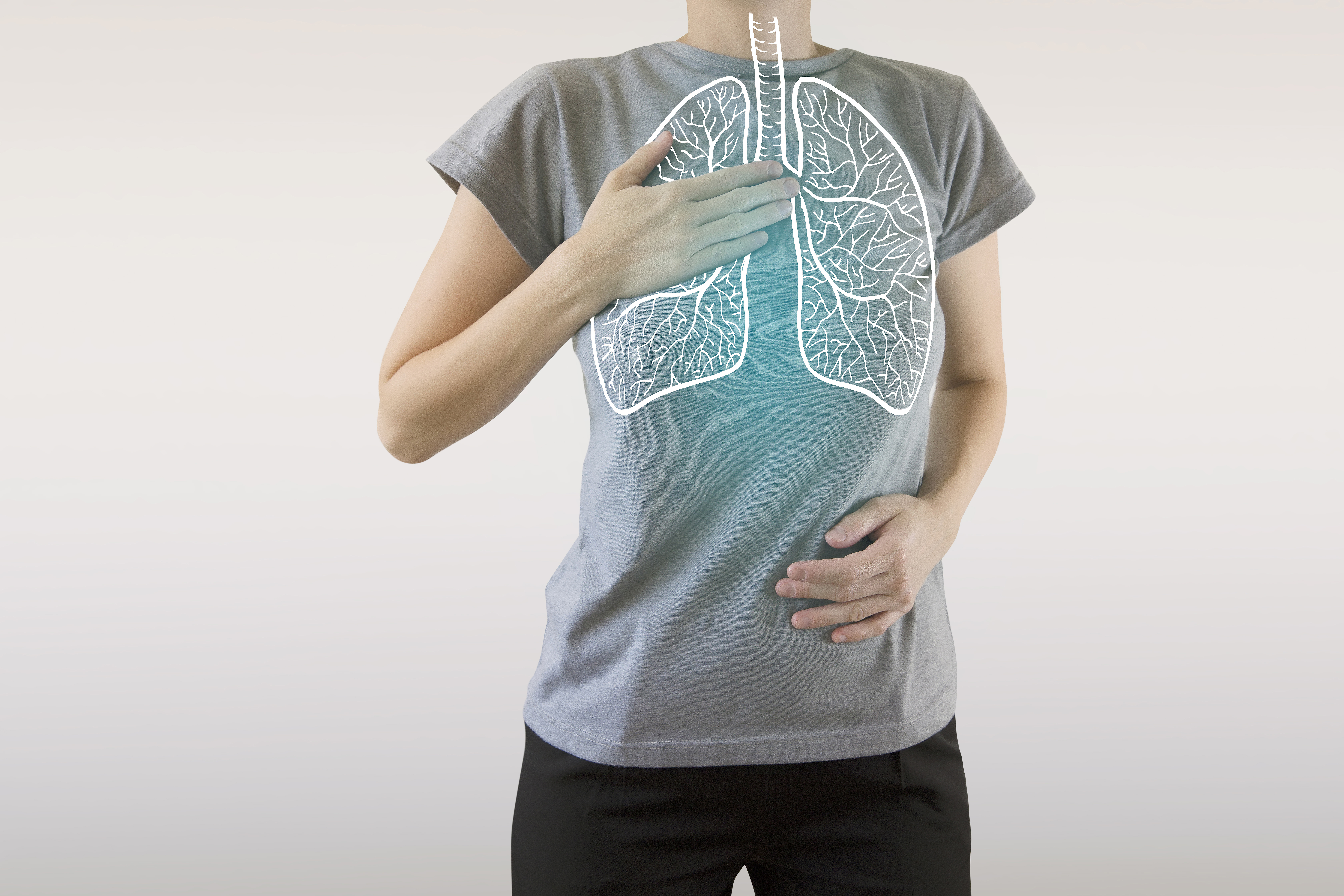 A person breathing in with an image of the lungs