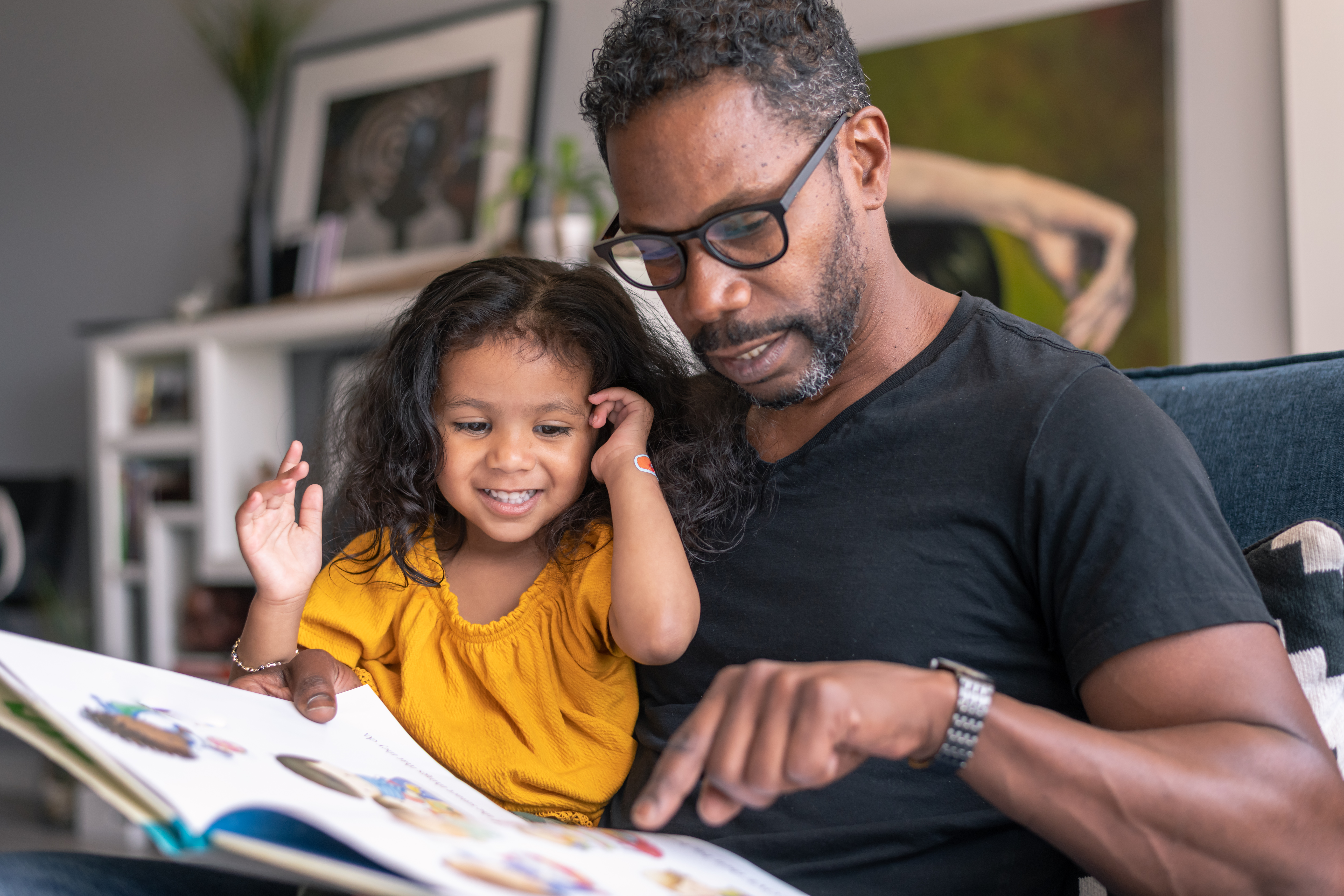 Father reading book with his daughter
