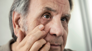 Glaucoma patient checking his eye