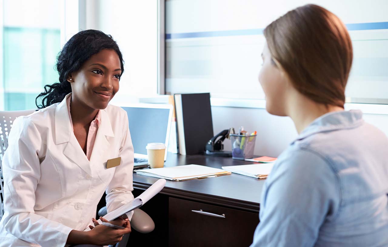 Doctor speaking to patient ahead of planned vaginal hysterectomy (womb removal surgery)
