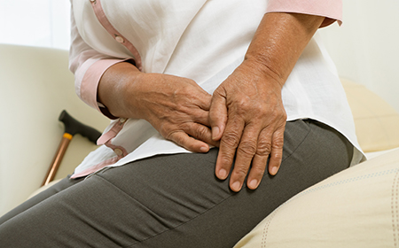 Patient practicing physiotherapy for groin strain exercises at home