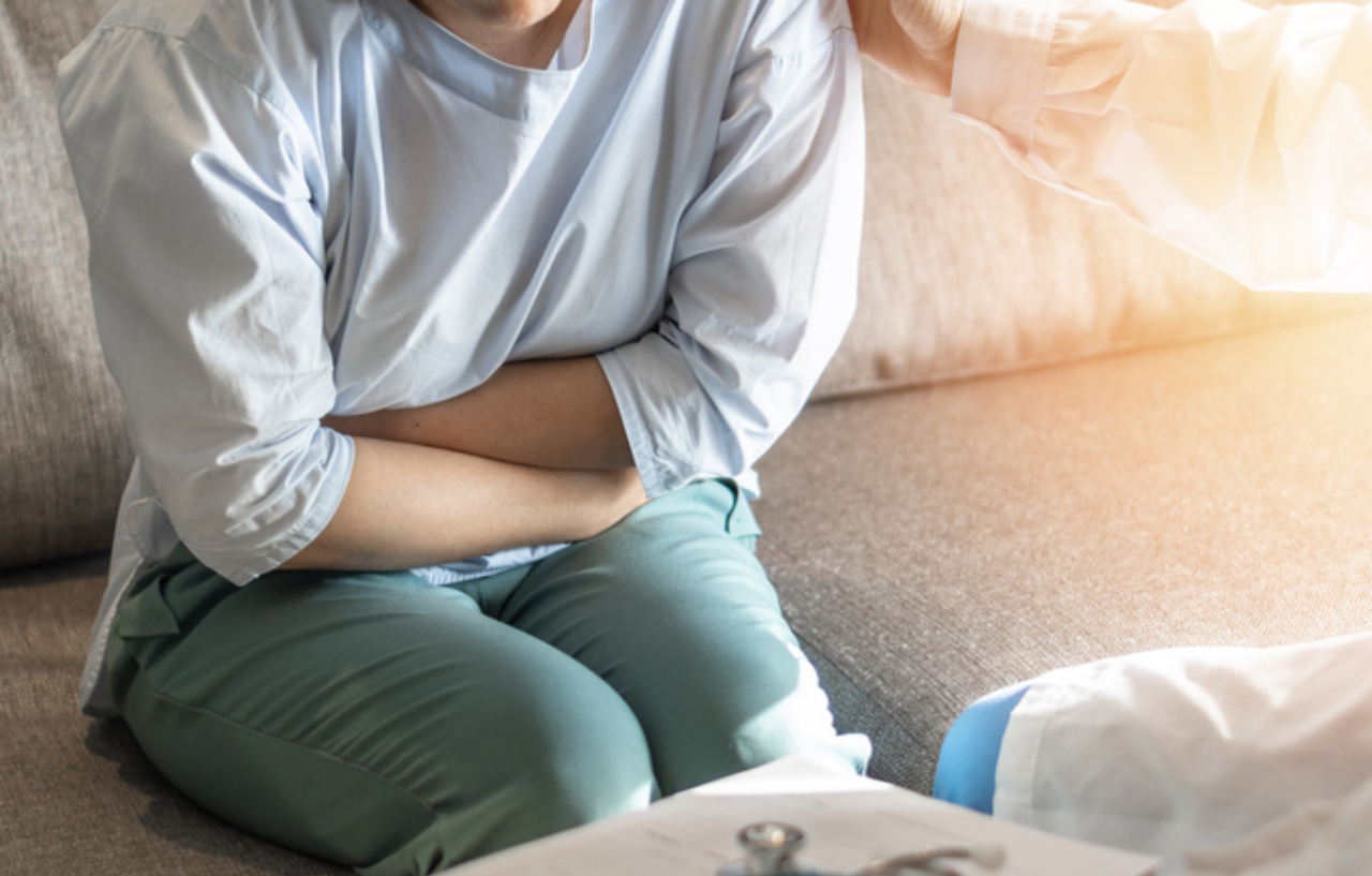 Woman experiencing abominal pain from diverticulitis symptoms