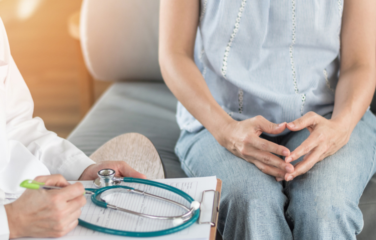 Woman awaiting cervical cancer treatment in consultation with a specialist