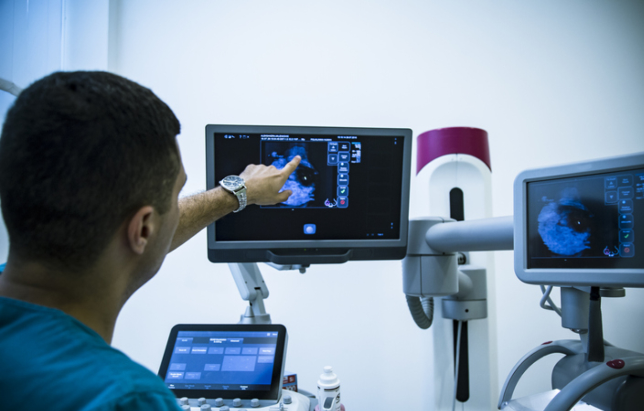 A breast cancer rapid access clinic appointment with a doctor examining a scan on a screen