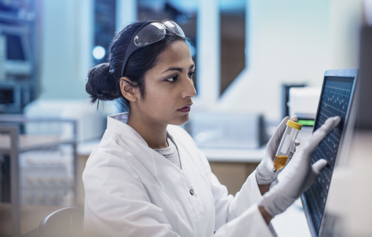 A scientist working in a lab that performs cancer screening and diagnostics tests