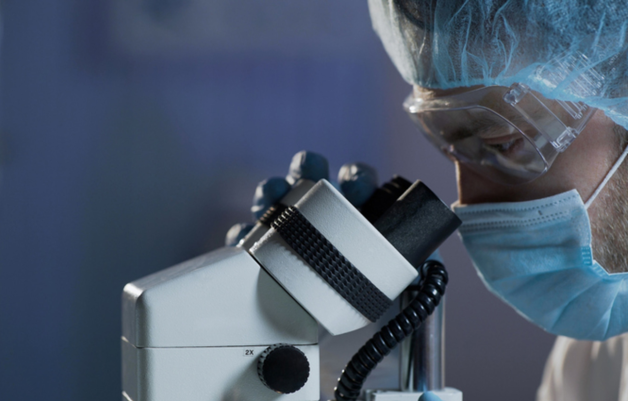 Medical scientist looking at blood sample to make blood cancer lymphoma diagnosis