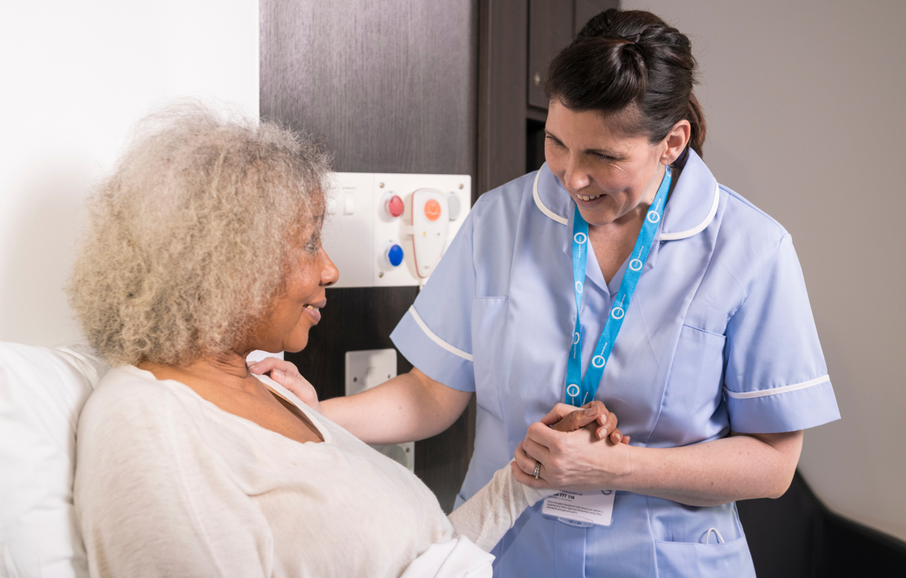 Nurse comforts a patient who underwent a nephrostomy procedure