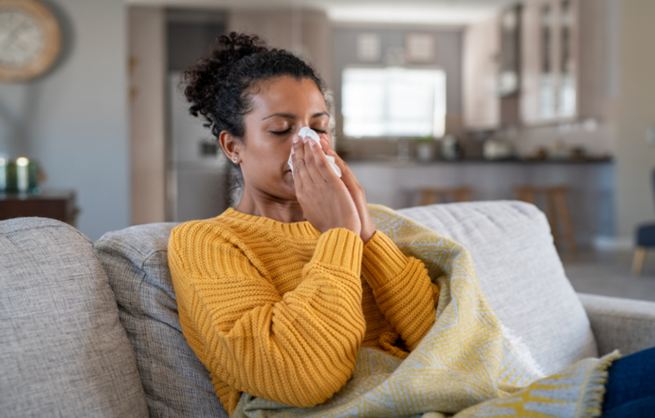 Woman blowing her nose ahead of nasal polypectomy surgery