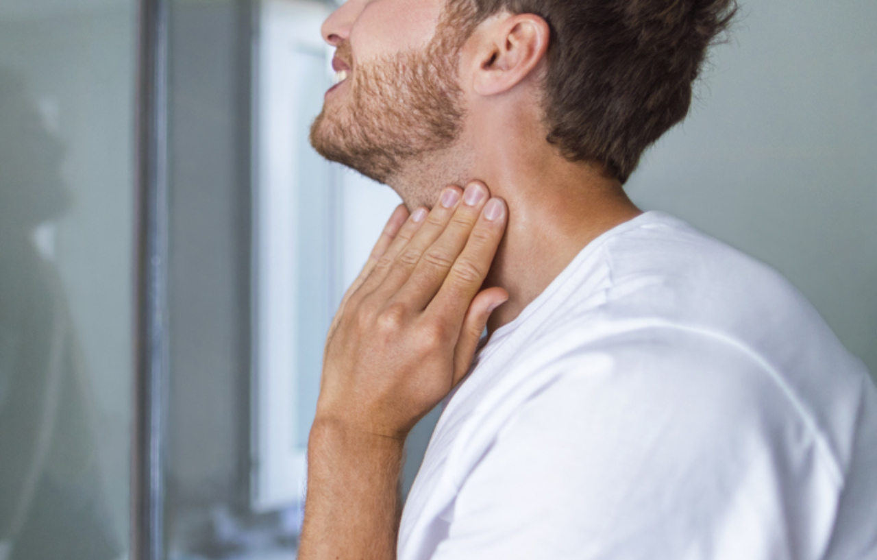 Thyroid-self-exam-checkup-young-man-touching-his-neck
