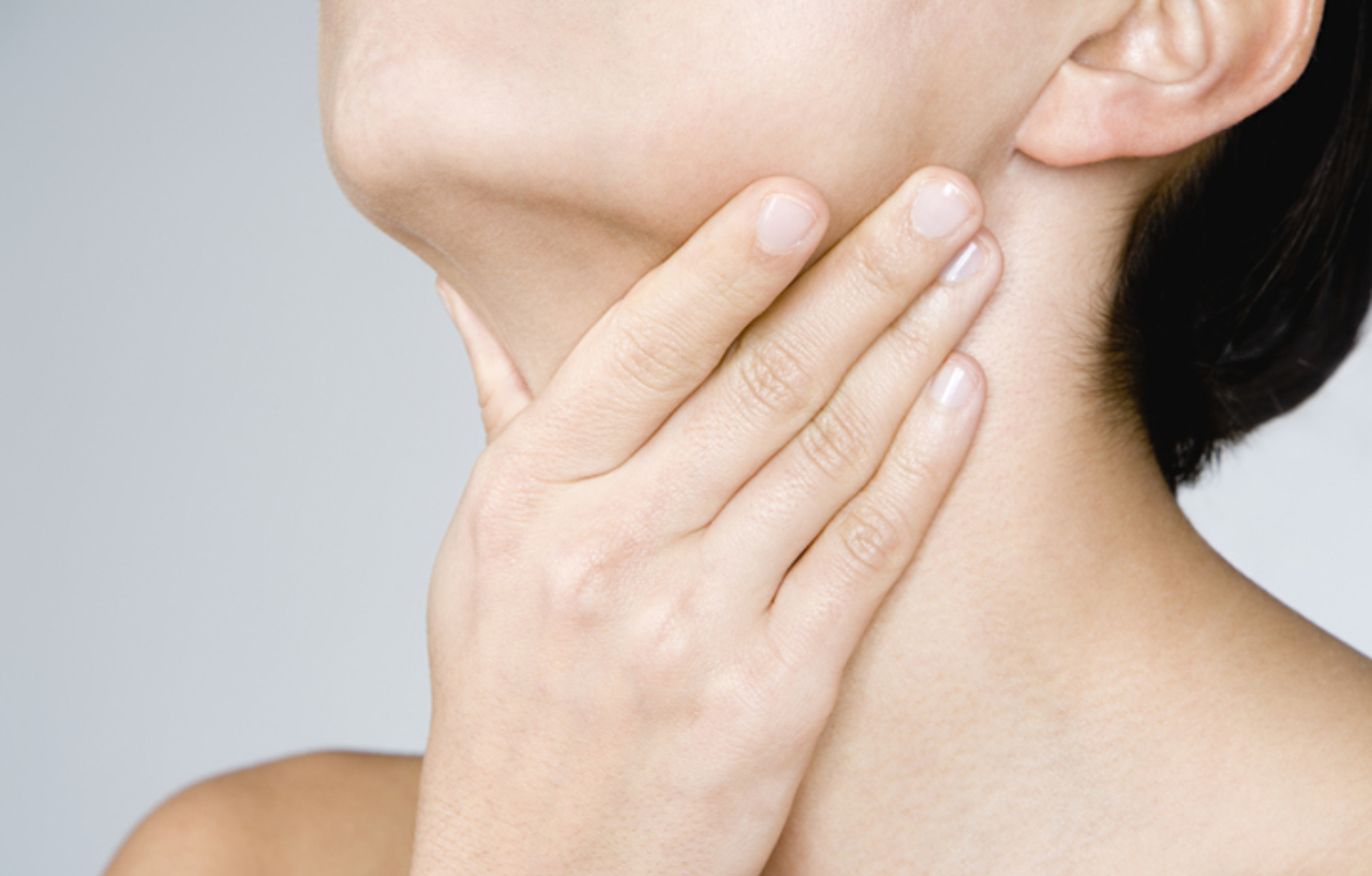 Woman holding her neck in discomfort needs a diagnosis and treatment for hoarseness