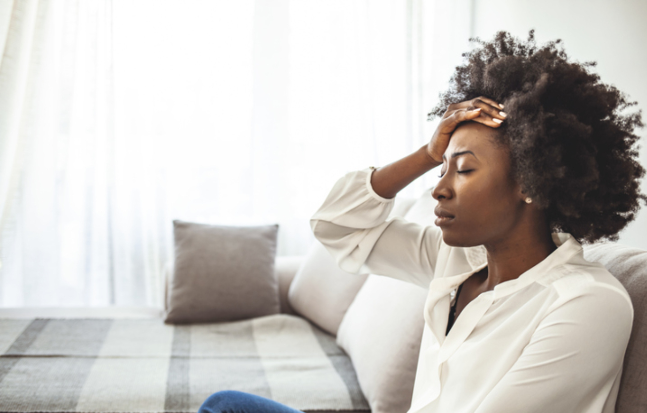 Young woman with a headache is about to start migraine treatment