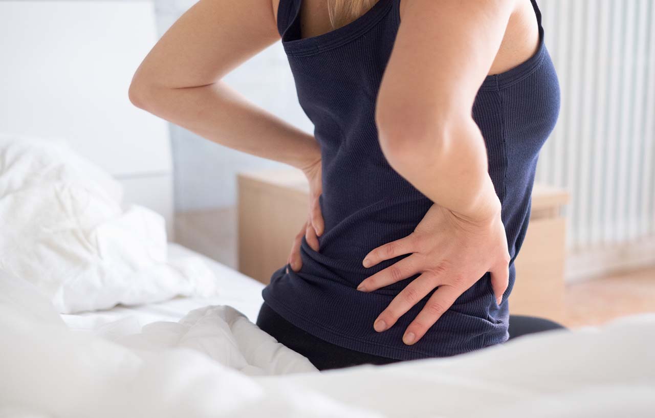 Woman-on-bed-with-hip-pain