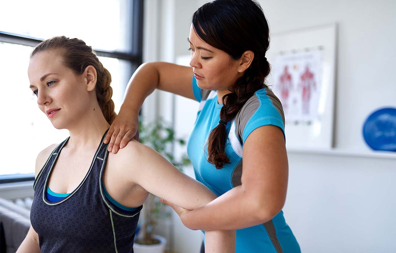 Woman receiving treatment for her dislocated shoulder in clinic