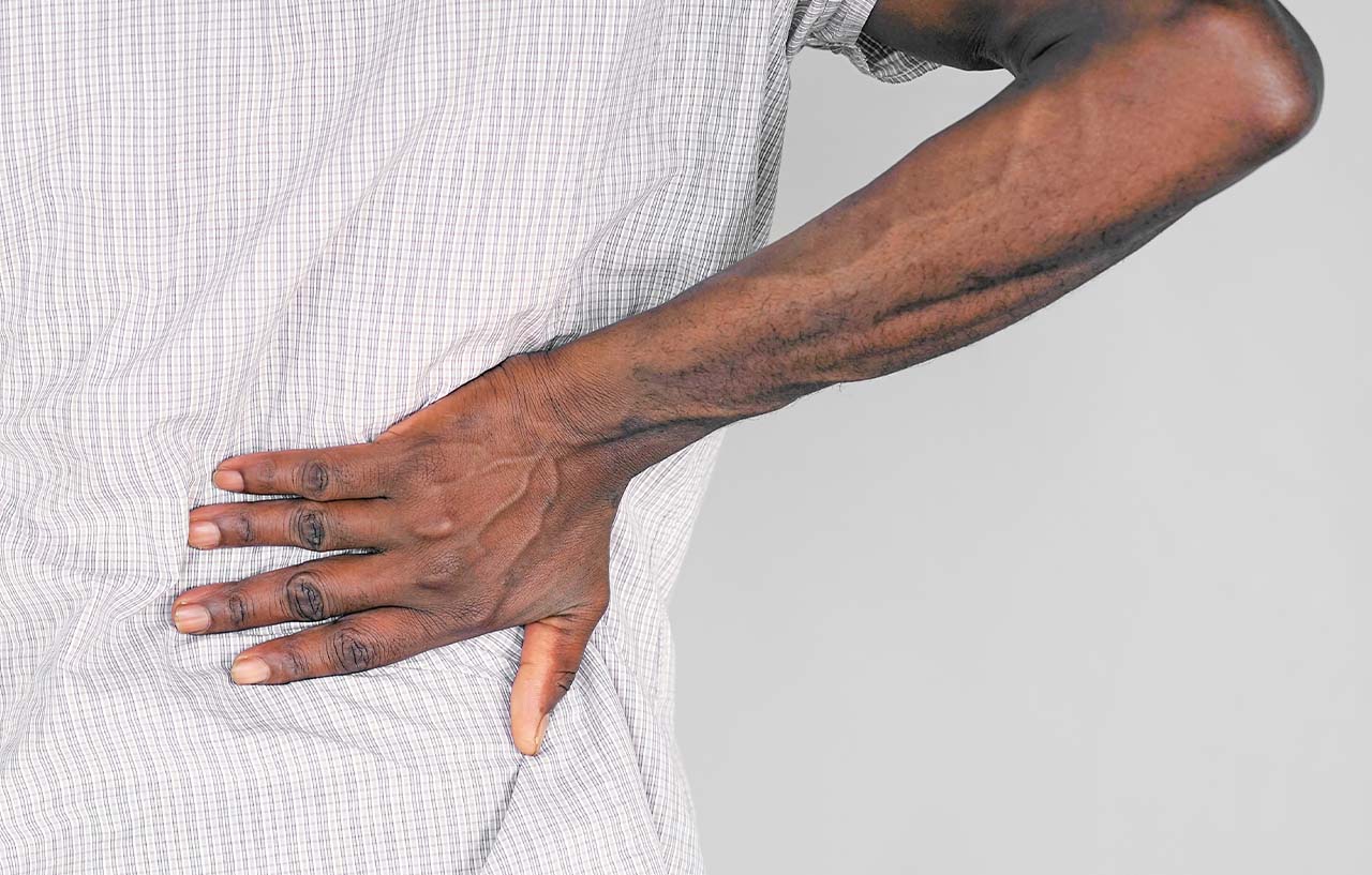 Man with back pain caused by fibromyalgia