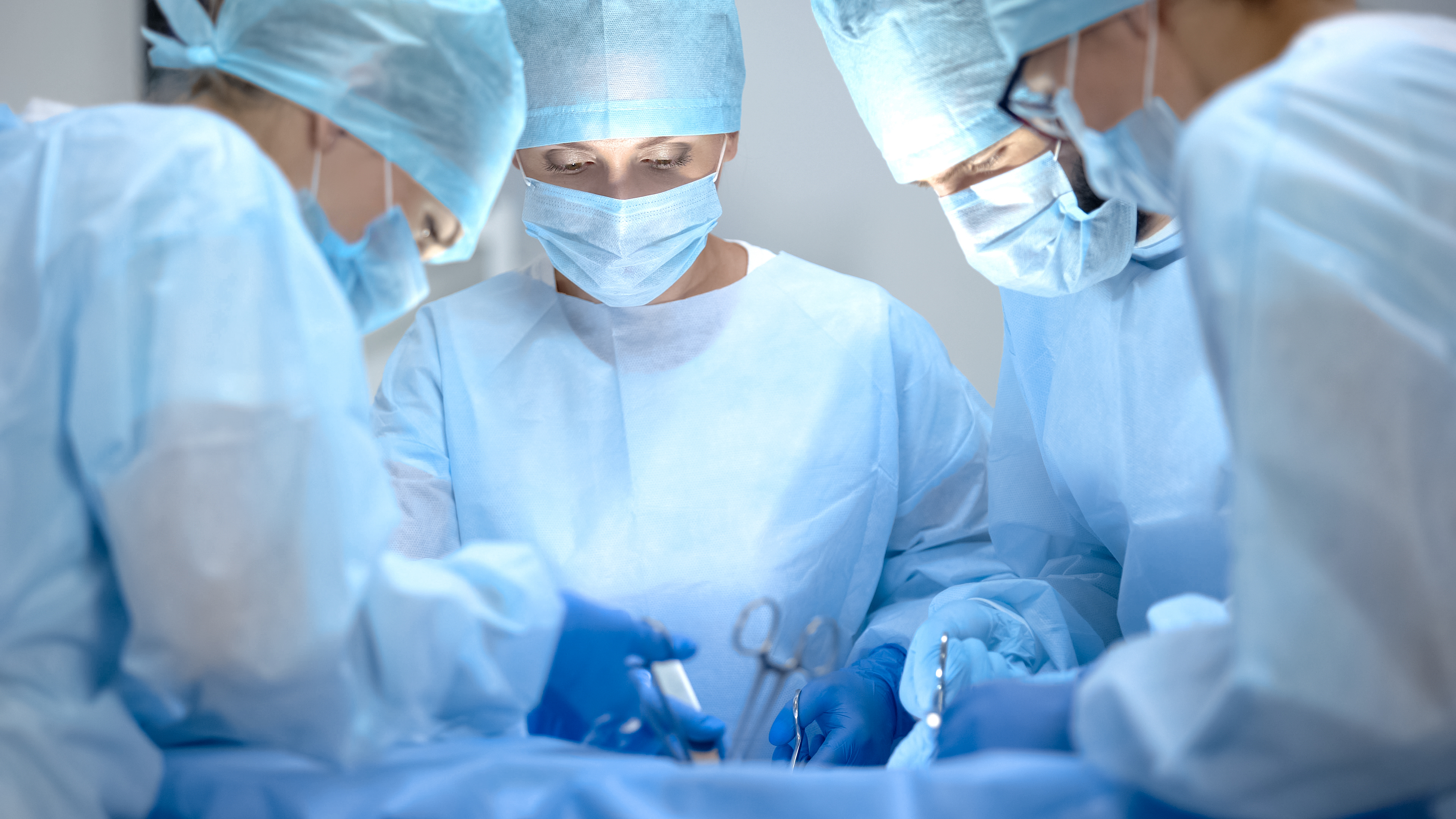 Surgeons in an operation theatre performing surgery