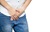Male hands holding on middle crotch of trousers with prostate inflammation