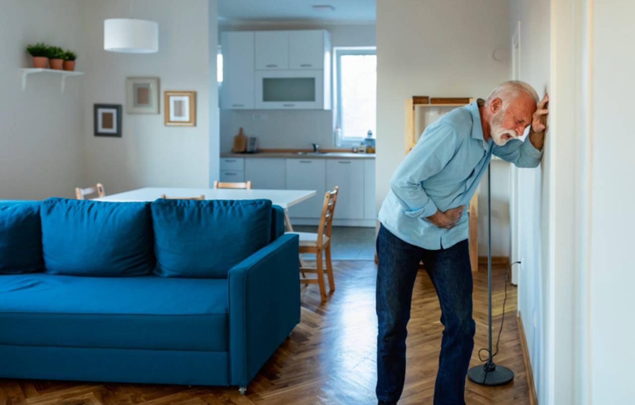 Man with interstitial cystitis (painful bladder syndrome) doubles over in pain