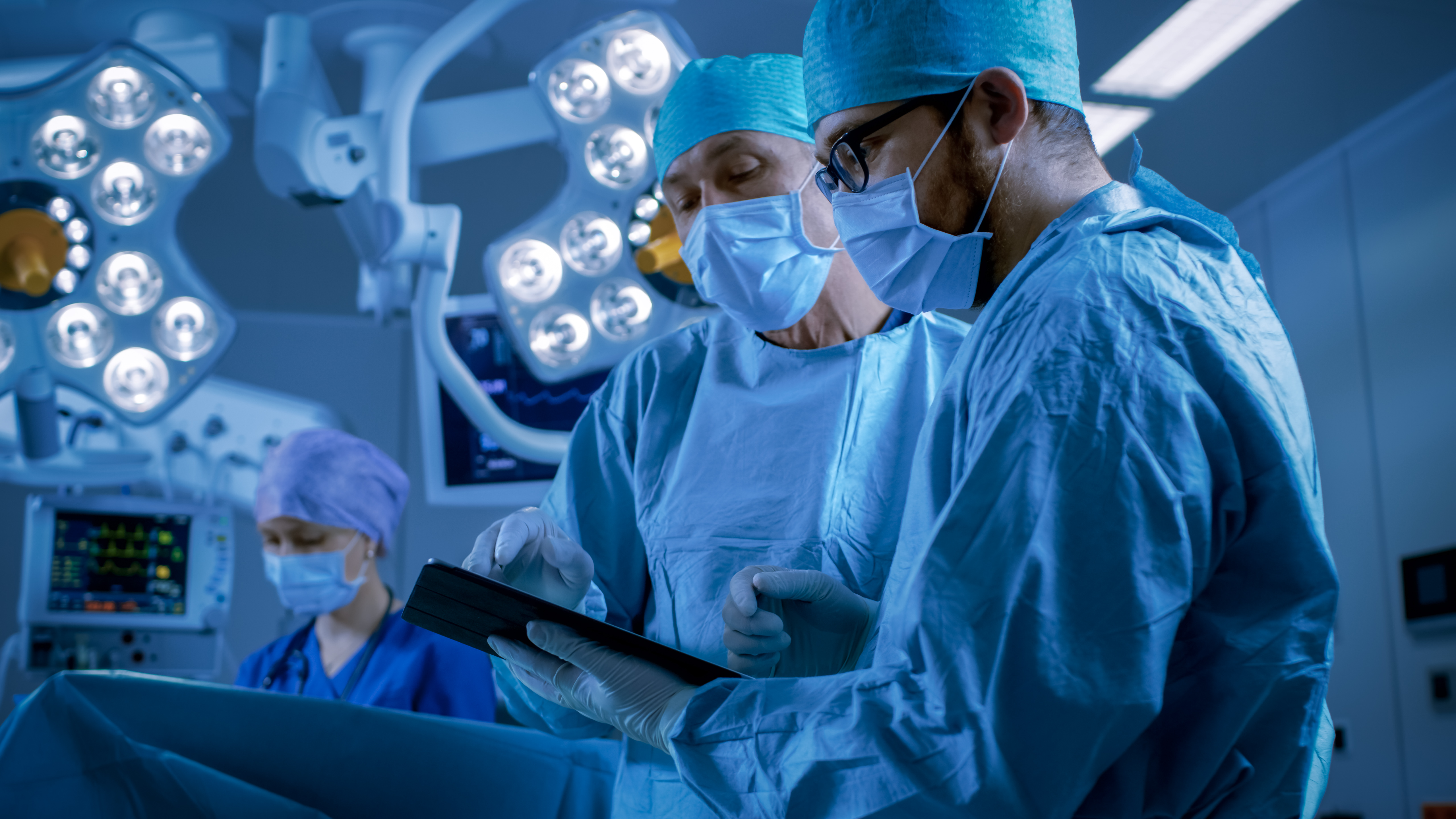 A theatre of surgeons assessing the procedure they are performing