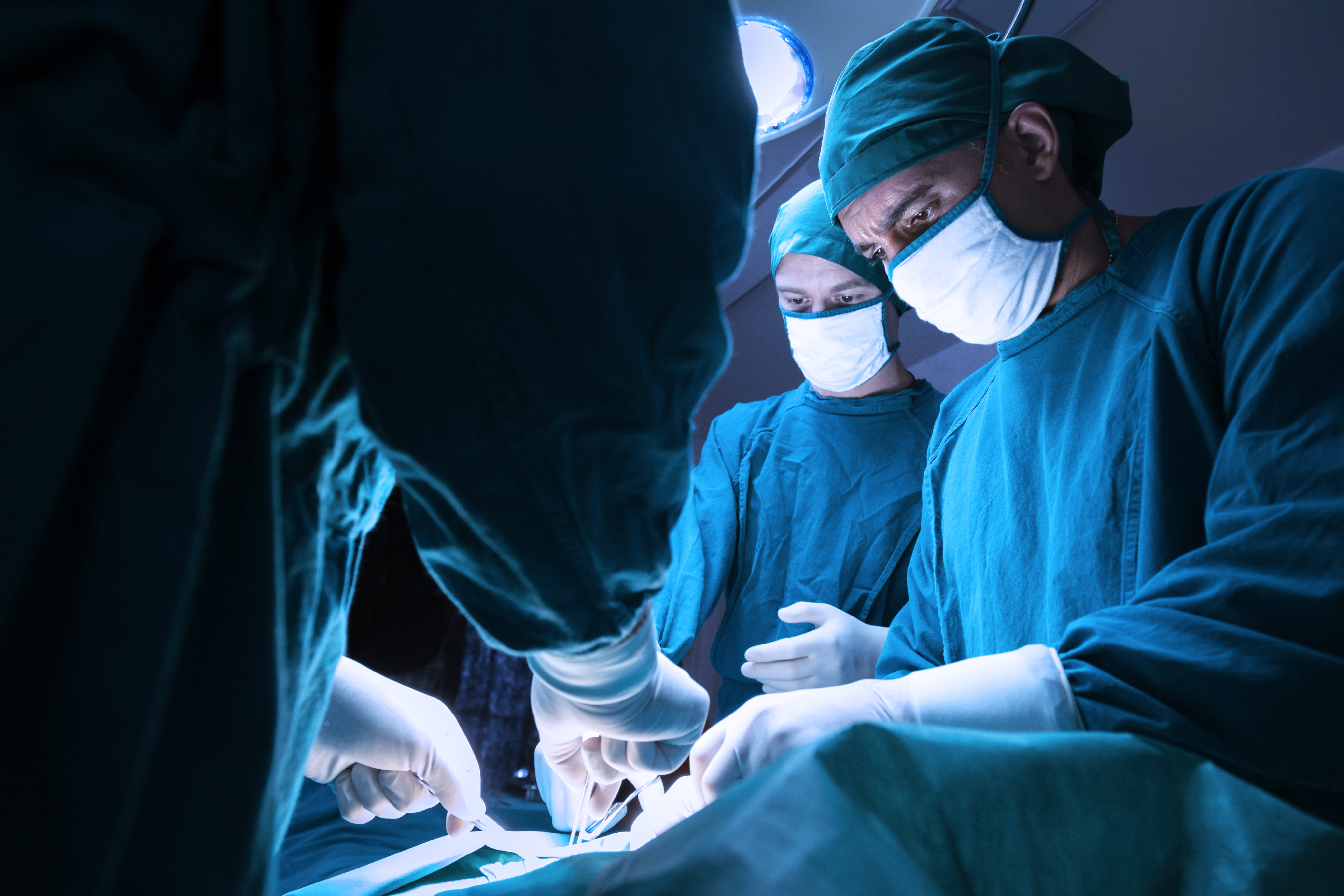 A group of surgeons performing surgery on a patient