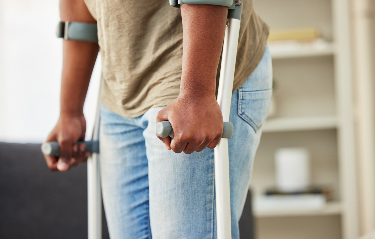 man-holding-crutches